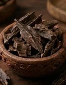 Oudh wood chips in a carved wooden bowl